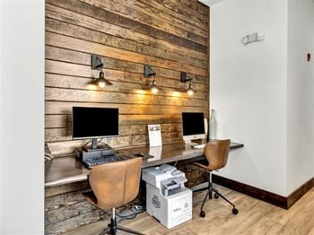 A home office with a desk and two computer monitors